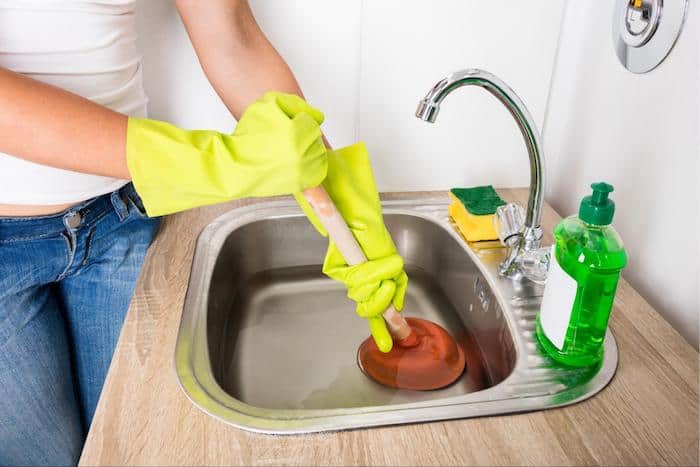 How do you unclog a sink with standing water?