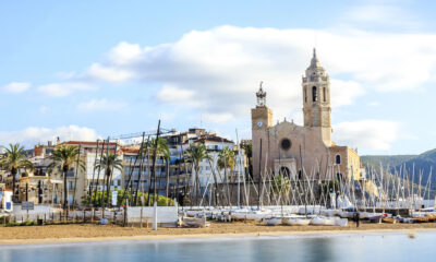 Where is Sitges located and what are the advantages of living there?
